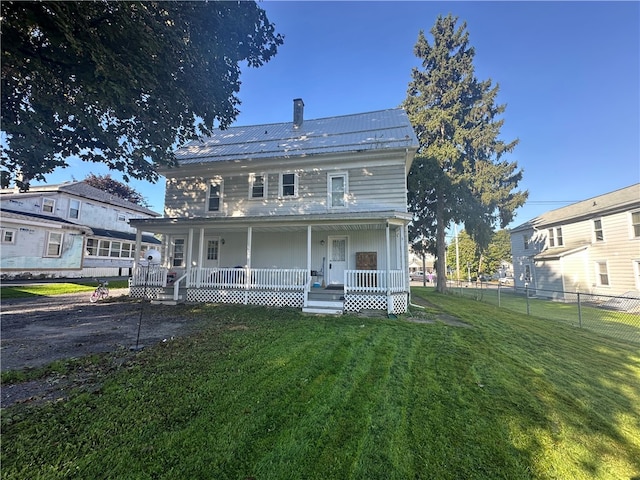 view of front of property with a front yard and covered porch