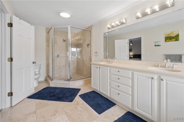 bathroom featuring vanity, toilet, ceiling fan, and a shower with door