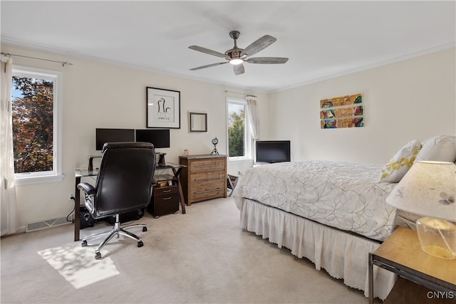 bedroom with ceiling fan, light colored carpet, and crown molding