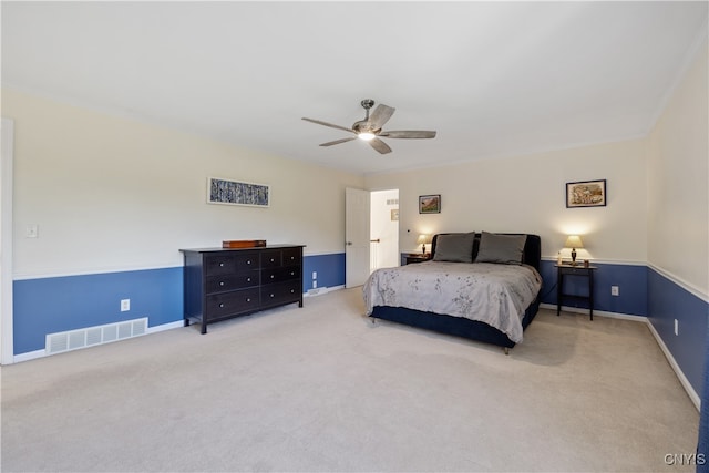 carpeted bedroom with ceiling fan and ornamental molding