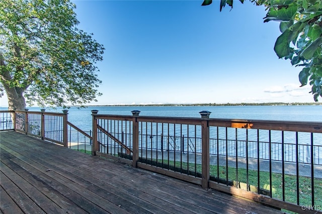 wooden terrace featuring a water view