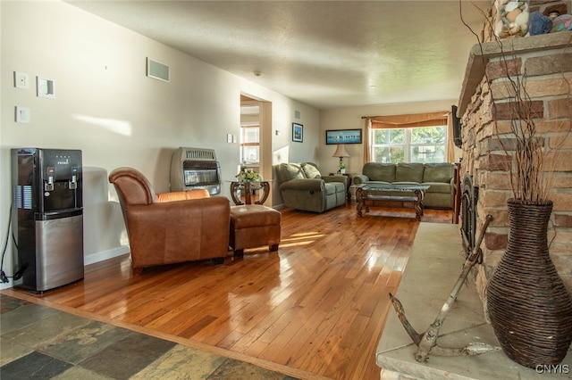 living room with hardwood / wood-style floors and heating unit