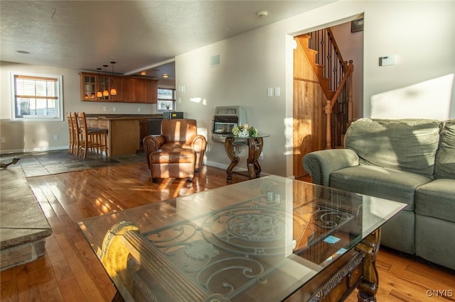 living room featuring dark wood-type flooring and heating unit