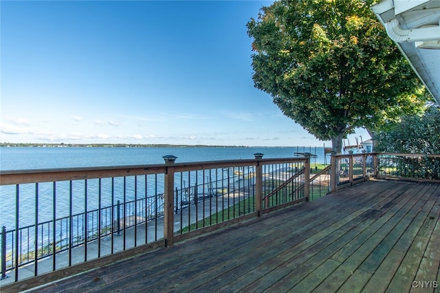 wooden deck featuring a water view