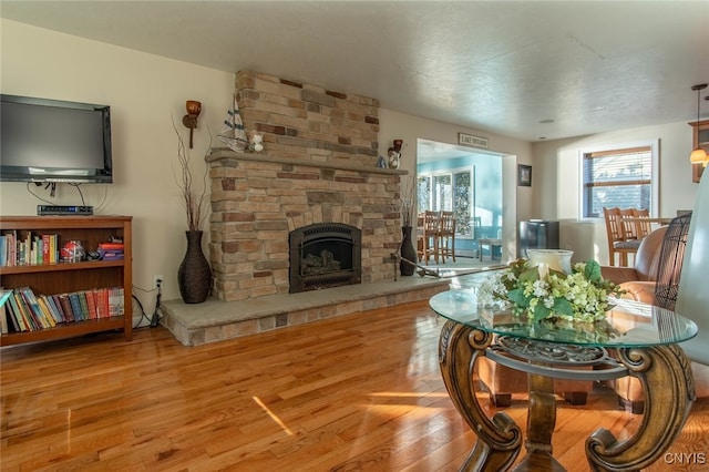 living room with a fireplace and hardwood / wood-style flooring