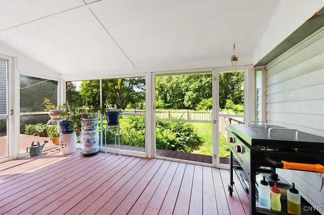 unfurnished sunroom featuring vaulted ceiling