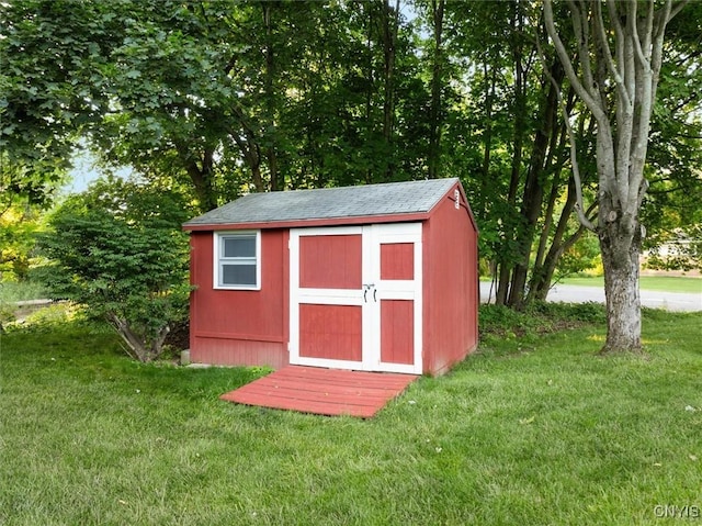 view of outbuilding featuring a yard