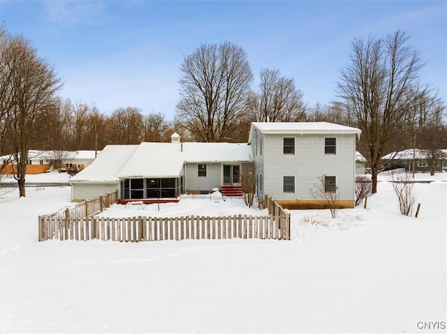 view of snow covered rear of property