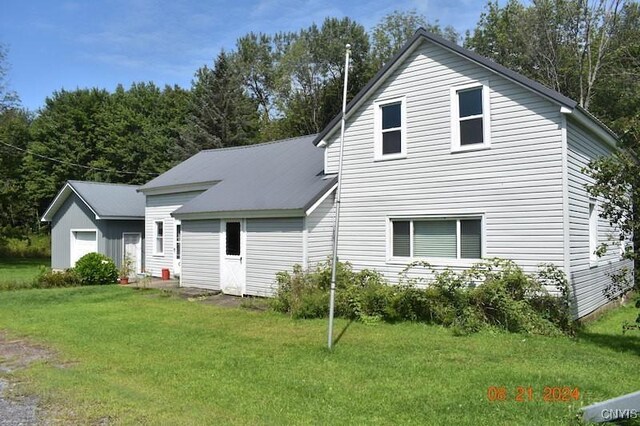 back of property featuring a lawn