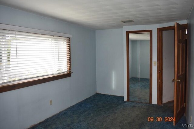 unfurnished bedroom with carpet flooring