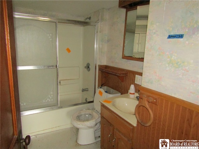 full bathroom featuring bath / shower combo with glass door, toilet, and vanity