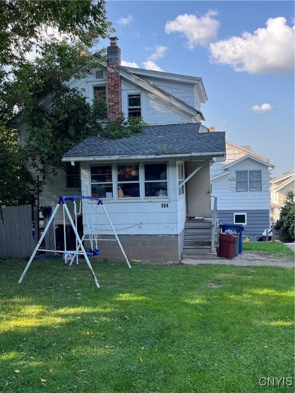 back of house with a yard