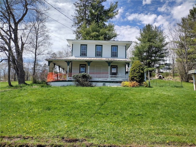 farmhouse inspired home with a front yard and a porch