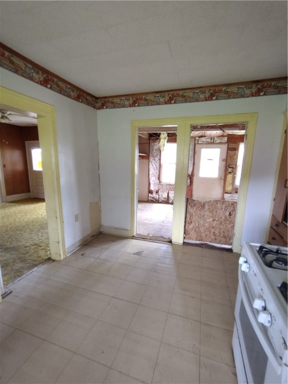 interior space with ceiling fan and light colored carpet