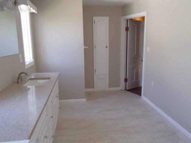 bathroom with baseboards and vanity