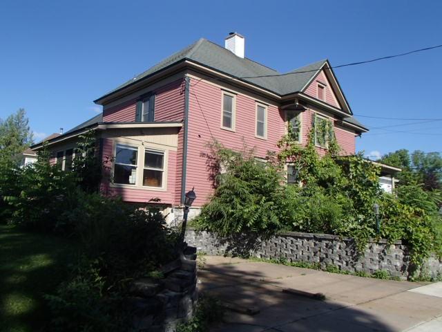 view of side of home featuring a chimney
