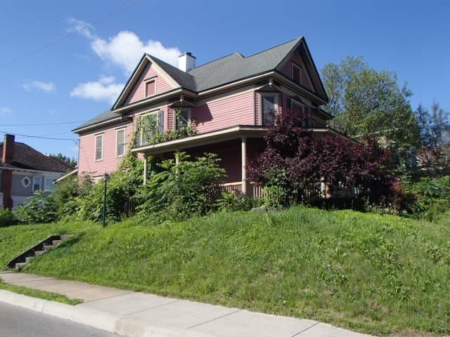 view of side of home with a yard