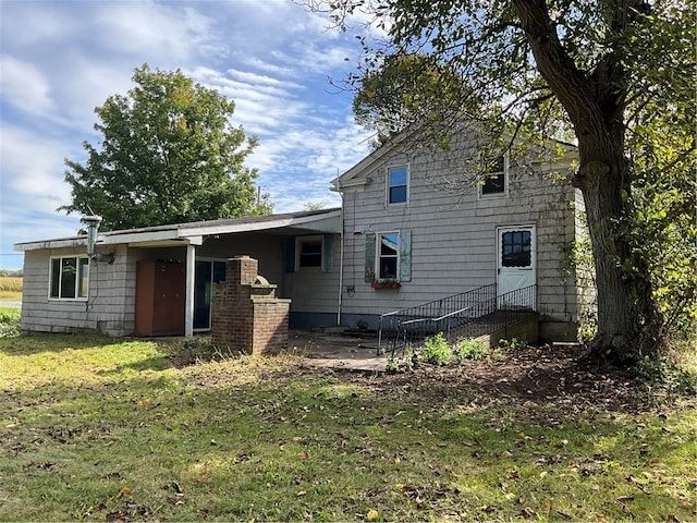 rear view of house with a yard