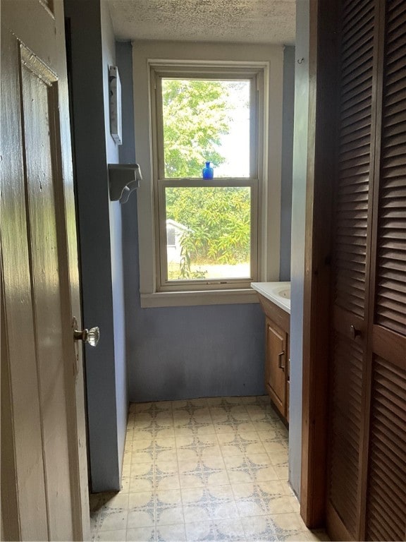 bathroom featuring a textured ceiling and vanity