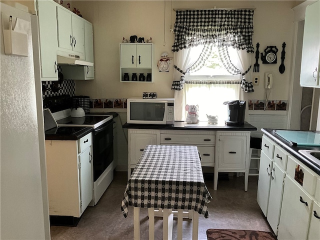 kitchen featuring white appliances and white cabinets