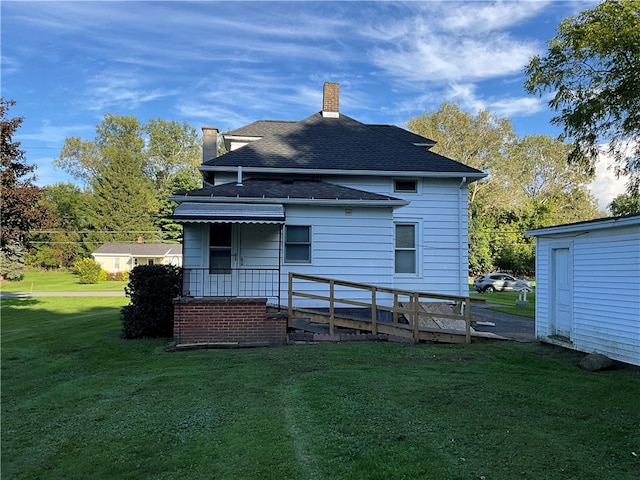 rear view of house featuring a yard