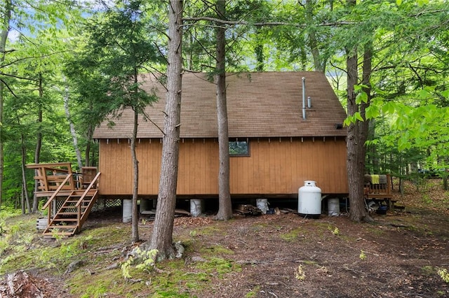 7682 Cottage Rd Unit 2, Wolcott, NY 14590 - view of side of home featuring stairs, a deck, and a shingled roof