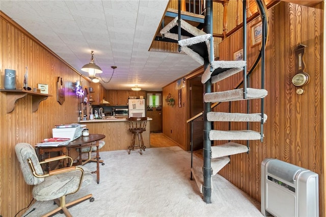 7682 Cottage Rd Unit 2, Wolcott, NY 14590 - dining room with stairway, light carpet, heating unit, and wood walls