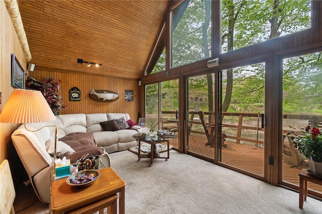 carpeted living room with wood ceiling and high vaulted ceiling