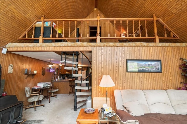 7682 Cottage Rd Unit 2, Wolcott, NY 14590 - carpeted living room with a wood stove, wooden walls, and lofted ceiling