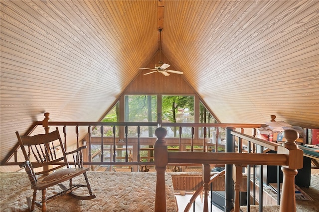 interior space featuring ceiling fan, wooden walls, and wood ceiling