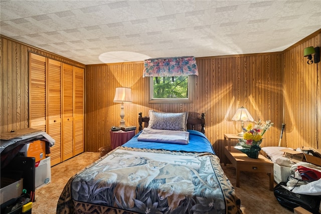 carpeted bedroom featuring wood walls and a closet