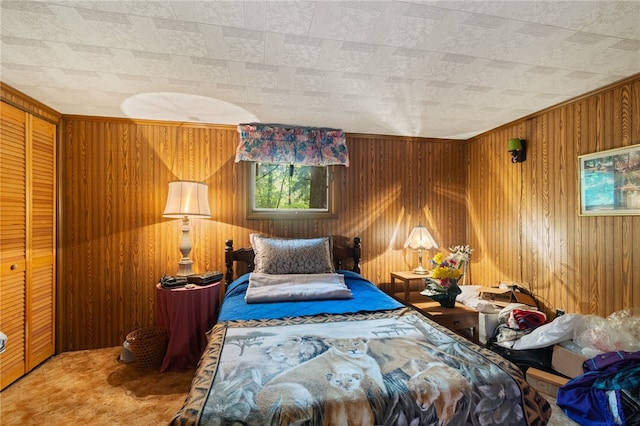 bedroom featuring carpet, wood walls, and a closet