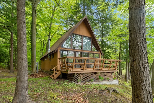 rear view of house with a wooden deck