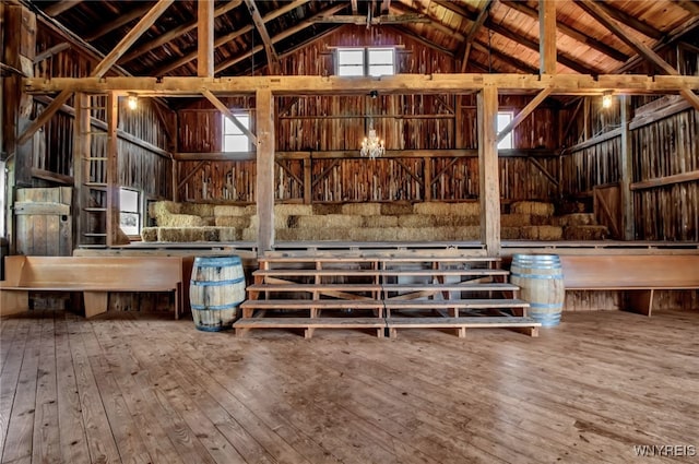 misc room featuring wood-type flooring, wood ceiling, beam ceiling, and high vaulted ceiling