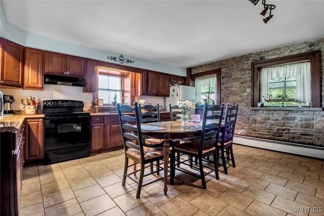 kitchen with black / electric stove, white fridge, and a baseboard heating unit