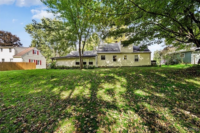 back of property featuring a lawn