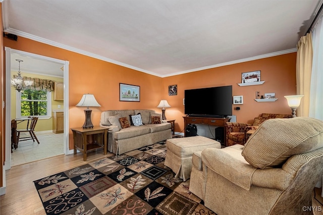 living room featuring ornamental molding, hardwood / wood-style floors, and a chandelier