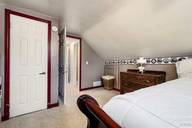 carpeted bedroom featuring lofted ceiling