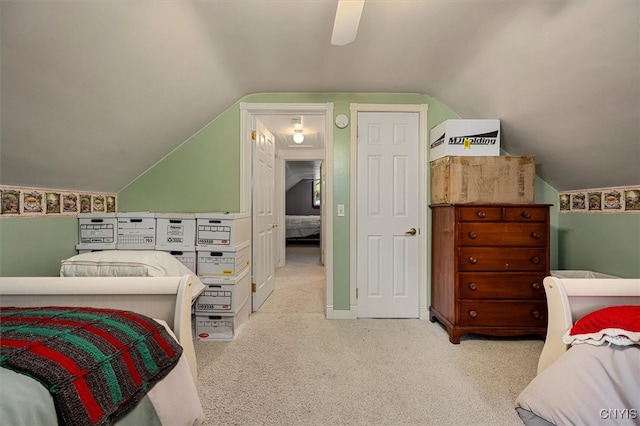 carpeted bedroom featuring ceiling fan and vaulted ceiling