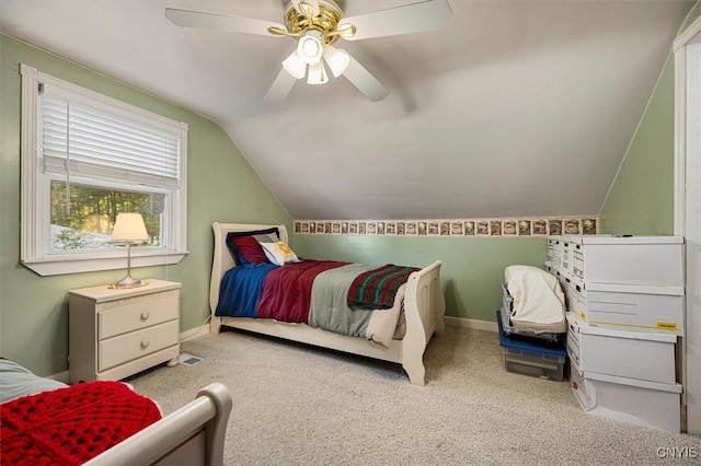 carpeted bedroom with vaulted ceiling and ceiling fan