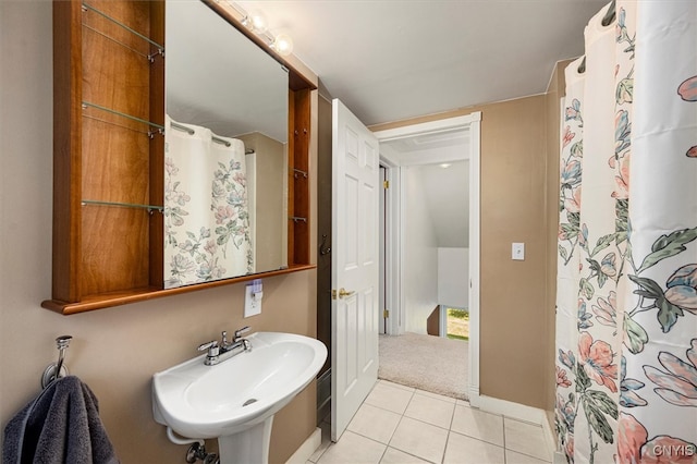 bathroom featuring tile patterned flooring, sink, and a shower with curtain