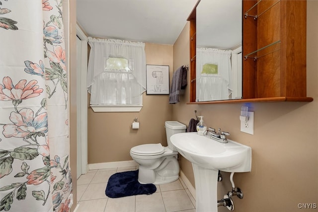 bathroom featuring walk in shower, toilet, and tile patterned floors