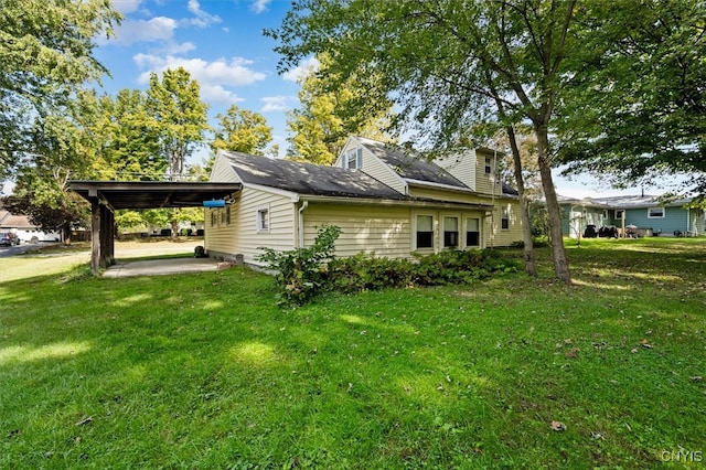 view of property exterior with a lawn and a carport