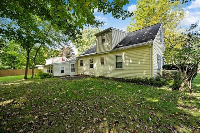 rear view of property with a yard