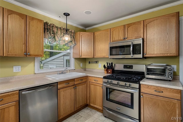 kitchen with hanging light fixtures, ornamental molding, sink, and stainless steel appliances