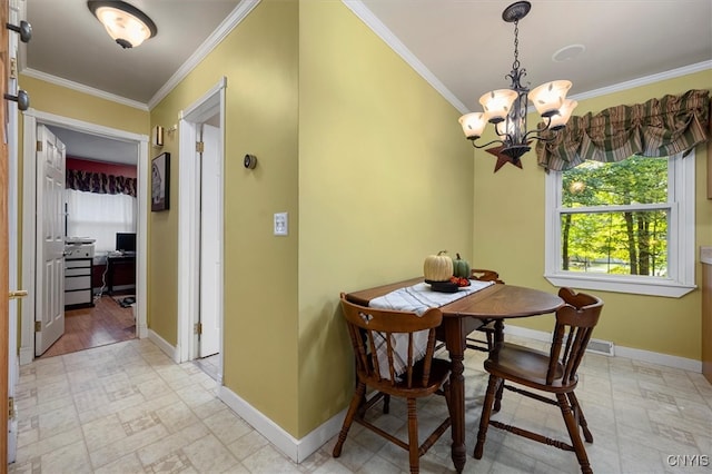 dining area featuring crown molding and an inviting chandelier