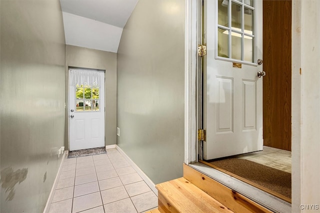 entryway featuring vaulted ceiling and light tile patterned floors