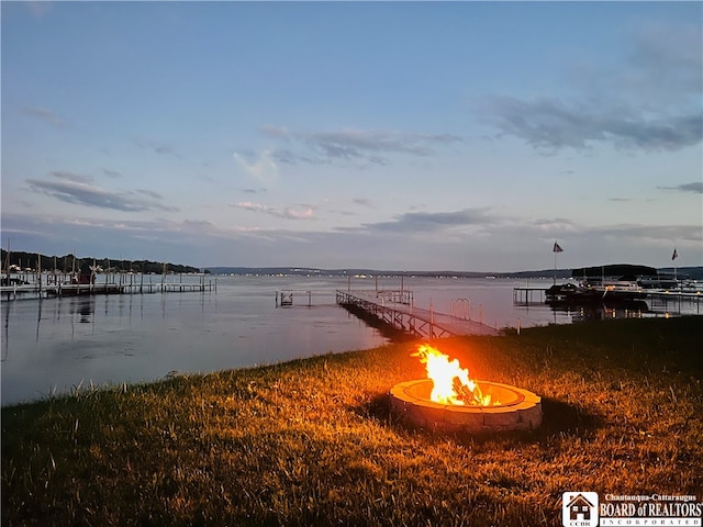 dock area featuring a water view and an outdoor fire pit