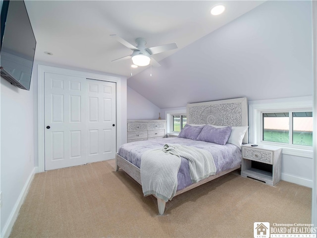 bedroom featuring a closet, ceiling fan, light carpet, and multiple windows