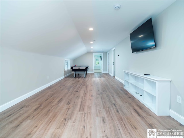 bonus room with lofted ceiling and light hardwood / wood-style flooring